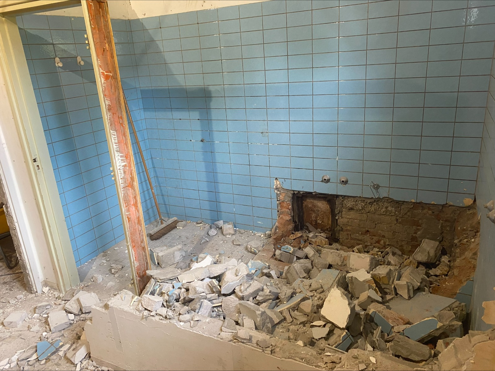 Badkamer tijdens renovatiesloop met verwijderd sanitair, tegelwerk en metselwerk